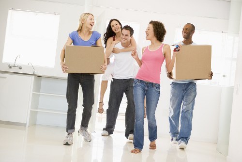 Removal crew carrying household items through a South Kensington property
